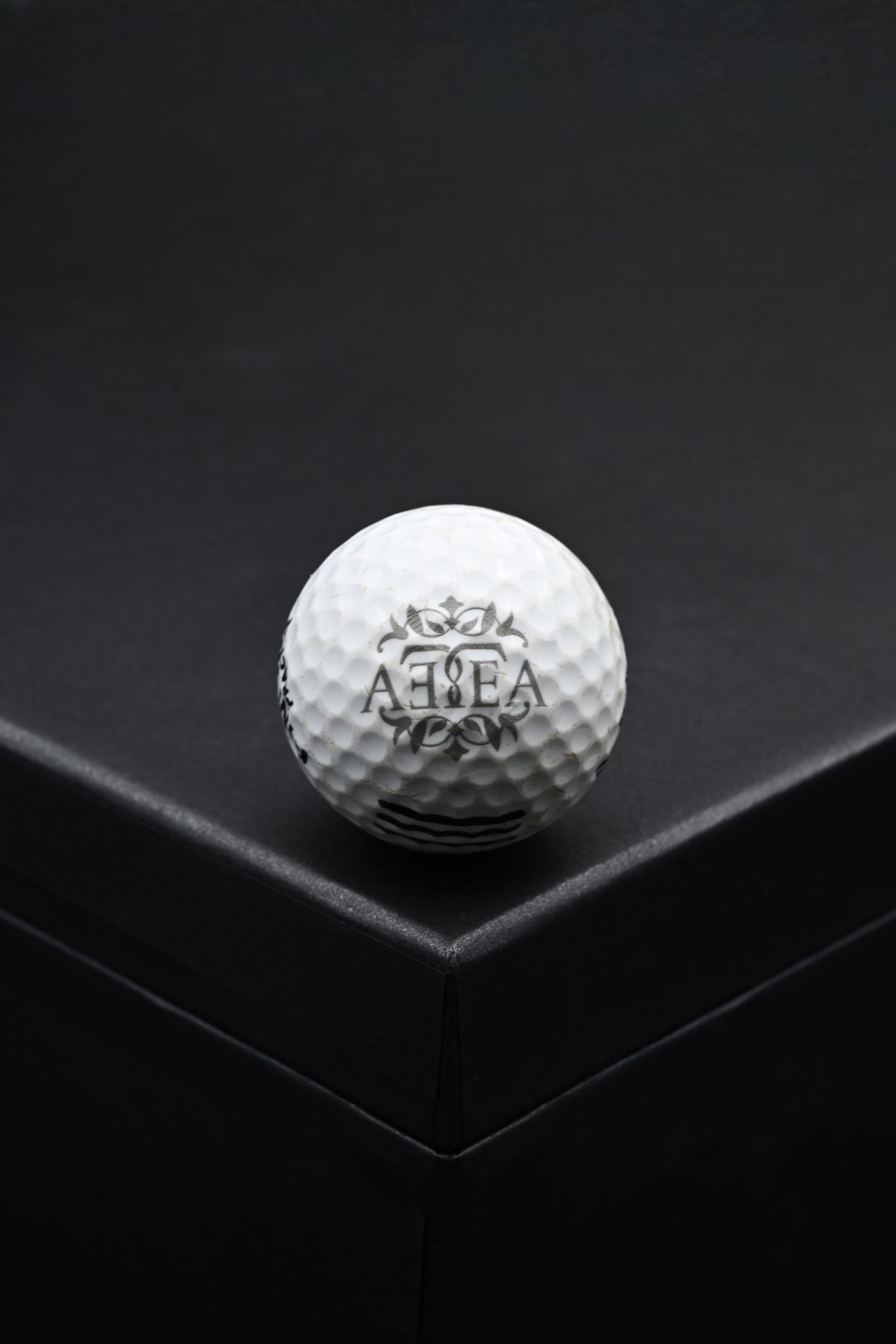 Golf ball engraved with the AETEA logo
