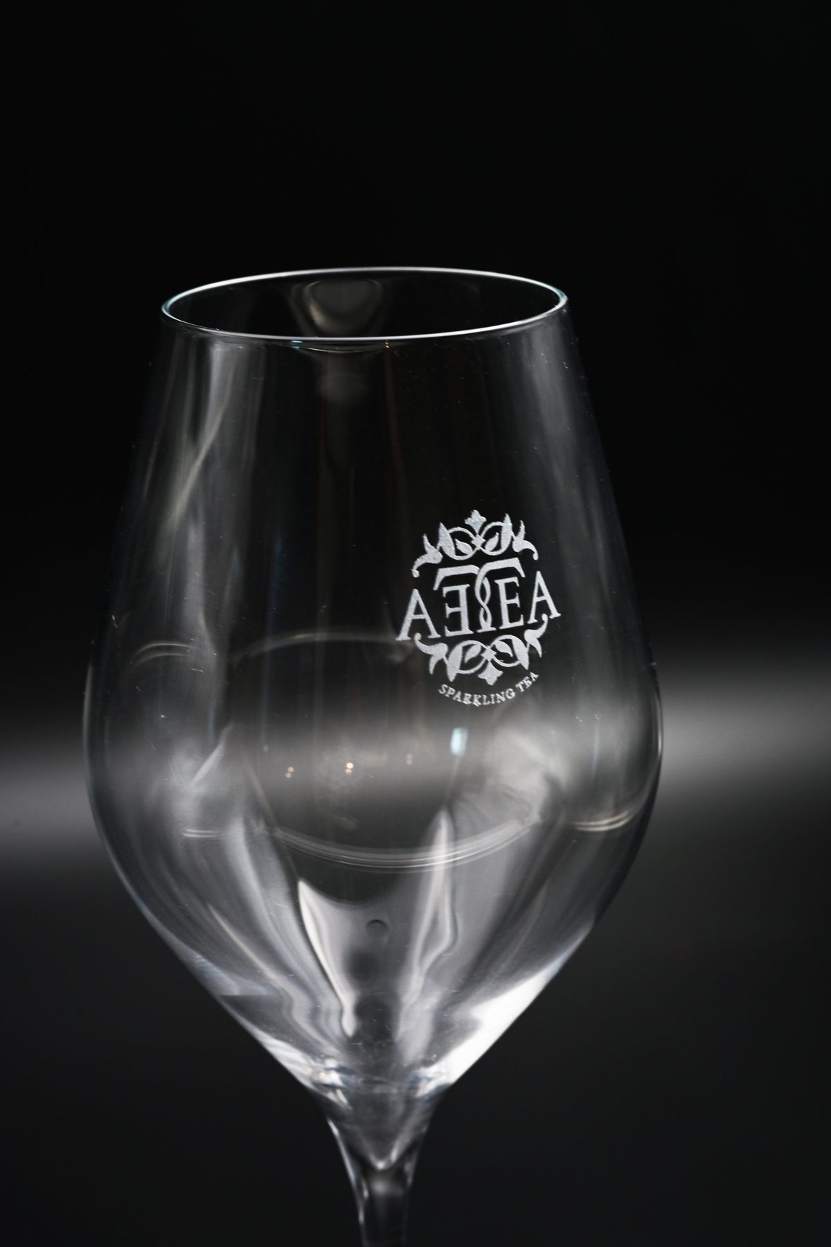 Wine glass engraved with a brand logo